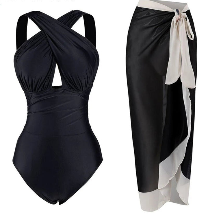 Conjunto de Enteriza Negra Lisa y Falda Pareo Estampada Ref. 0561 - Marea Bella Swimwear